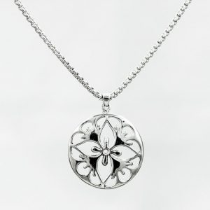 round silver pendant with cut-out pattern